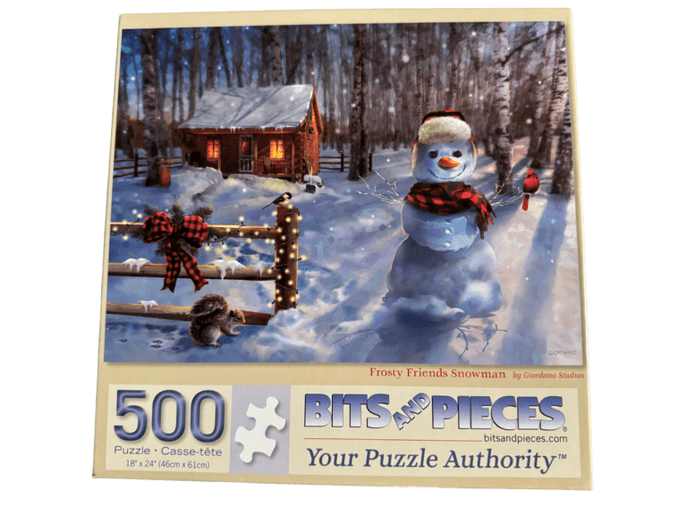 A snowman is standing in the snow near a log fence.