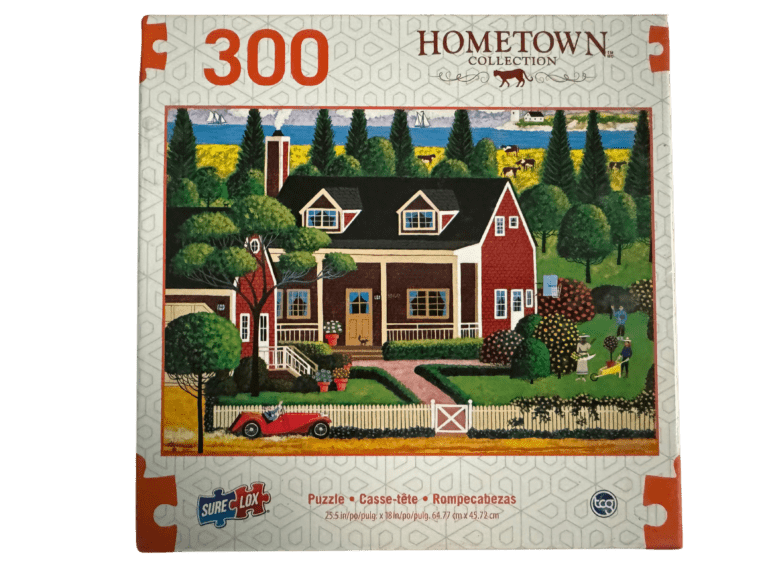 A puzzle of a house with trees and a red truck.