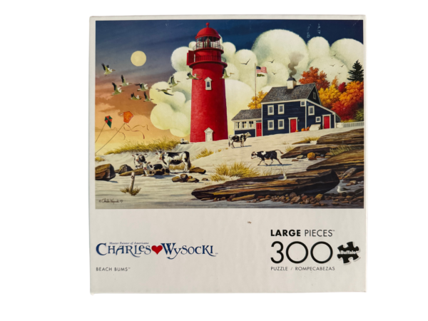 Red lighthouse and cows on beach 300 piece puzzle.